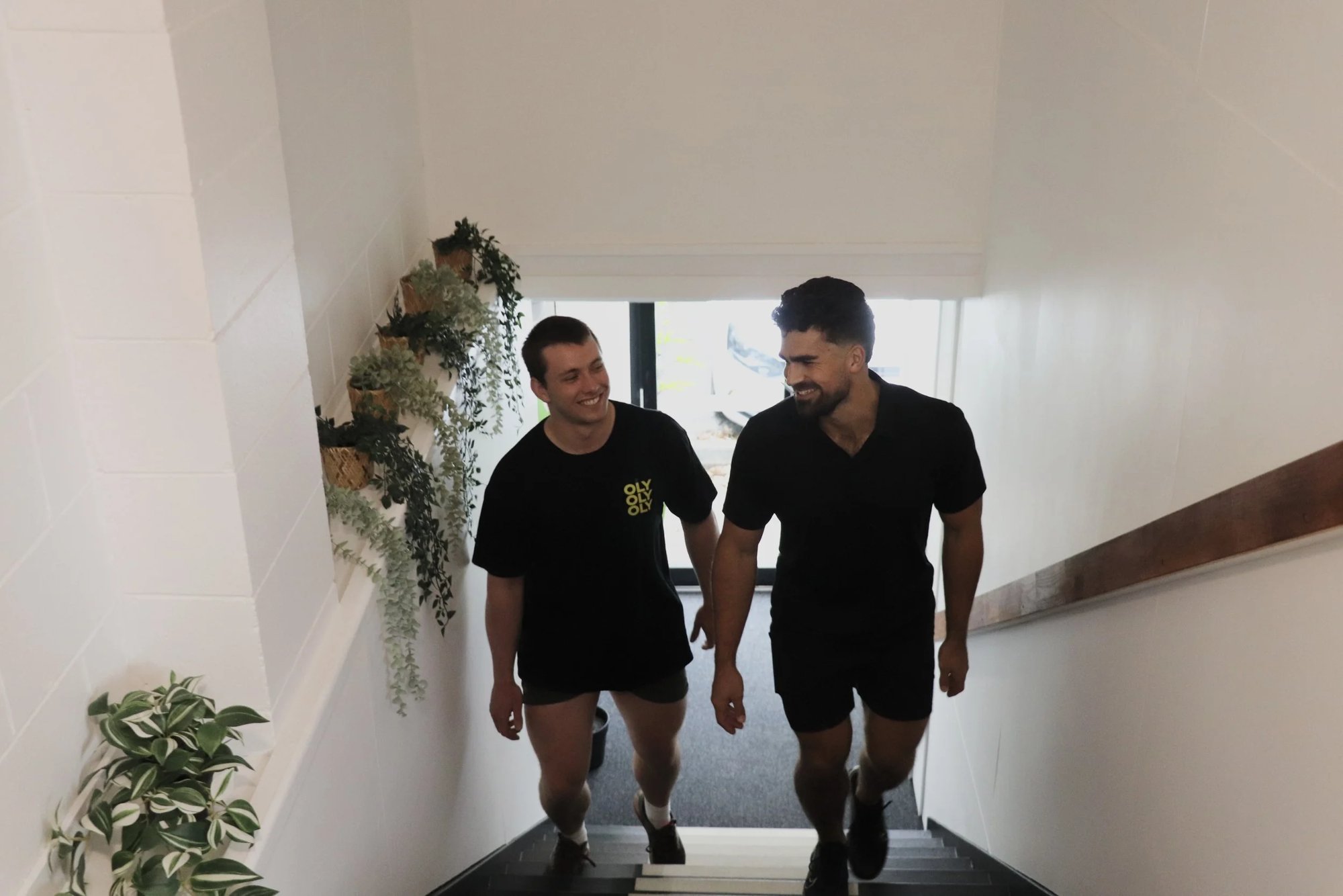 Ahrie and a client heading up the stairs to the clinic
